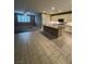 Open-concept kitchen and living space with white kitchen cabinets and bright living room at 4108 Fairywren Dr, North Las Vegas, NV 89031