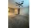 Living room with carpeting, a ceiling fan, and access to a tiled area at 4108 Fairywren Dr, North Las Vegas, NV 89031