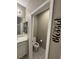 View of a powder room featuring a toilet and sink, plus an adjacent doorway at 4108 Fairywren Dr, North Las Vegas, NV 89031