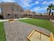 Beautiful backyard featuring artificial turf, horseshoe pits and partially-covered patio at 412 Orchid Oasis Ave, North Las Vegas, NV 89031
