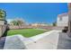 Spacious backyard area with artificial turf, concrete patio and block wall fencing at 412 Orchid Oasis Ave, North Las Vegas, NV 89031