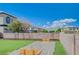 Backyard featuring a horseshoe pit, artificial grass, and a block wall at 412 Orchid Oasis Ave, North Las Vegas, NV 89031