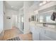 Bright bathroom featuring a double vanity, shower, and tile flooring at 412 Orchid Oasis Ave, North Las Vegas, NV 89031