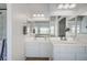 Bathroom featuring double sinks, well lit mirrors, and a neutral color scheme at 412 Orchid Oasis Ave, North Las Vegas, NV 89031