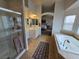 Bright primary bathroom features a soaking tub, shower, dual vanities, and ample natural light at 412 Orchid Oasis Ave, North Las Vegas, NV 89031