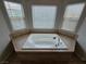 A bright and airy bathroom features a built-in soaking tub, perfect for relaxation and rejuvenation at 412 Orchid Oasis Ave, North Las Vegas, NV 89031