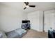 Neutral bedroom features a ceiling fan, carpeted floors, and closet at 412 Orchid Oasis Ave, North Las Vegas, NV 89031