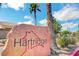 Hartridge community sign with palm trees set against a bright blue sky with scattered clouds at 412 Orchid Oasis Ave, North Las Vegas, NV 89031