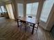 A cozy dining nook features wood-look flooring and large windows, creating an inviting space for meals at 412 Orchid Oasis Ave, North Las Vegas, NV 89031