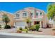 Charming two-story home featuring a well-manicured front yard and a two car garage at 412 Orchid Oasis Ave, North Las Vegas, NV 89031