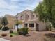 Inviting two-story home featuring well-maintained landscaping and a covered front porch at 412 Orchid Oasis Ave, North Las Vegas, NV 89031