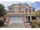 Charming two-story home with a two car garage and nicely maintained front yard at 412 Orchid Oasis Ave, North Las Vegas, NV 89031