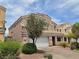 Charming two-story home with a two car garage, desert landscaping, and a tile roof at 412 Orchid Oasis Ave, North Las Vegas, NV 89031
