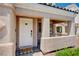 Charming front door with a welcoming hello mat, and covered porch at 412 Orchid Oasis Ave, North Las Vegas, NV 89031