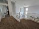 A cozy hallway features plush carpet and provides an airy view of the living and dining area below at 412 Orchid Oasis Ave, North Las Vegas, NV 89031