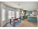 Bright kitchen features green cabinets, stainless steel appliances and an eat-in dining area at 412 Orchid Oasis Ave, North Las Vegas, NV 89031