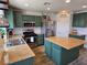 Renovated kitchen featuring stainless steel appliances, a kitchen island, and wooden floors at 412 Orchid Oasis Ave, North Las Vegas, NV 89031