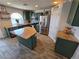 Updated kitchen with stainless steel appliances, a center island, and granite countertops at 412 Orchid Oasis Ave, North Las Vegas, NV 89031