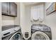 Laundry room with modern, front-load washer and dryer at 412 Orchid Oasis Ave, North Las Vegas, NV 89031