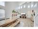 Bright living area with high ceilings, and a rustic wooden dining table and bench at 412 Orchid Oasis Ave, North Las Vegas, NV 89031