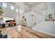 Bright living room featuring a high ceiling, wooden floors, and staircase with white railings at 412 Orchid Oasis Ave, North Las Vegas, NV 89031