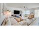 Spacious living area with a comfortable sectional sofa and an electric fireplace at 412 Orchid Oasis Ave, North Las Vegas, NV 89031