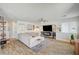 Bright living room with a plush sofa, stylish decor, and a modern fireplace at 412 Orchid Oasis Ave, North Las Vegas, NV 89031
