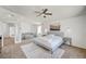 Spacious main bedroom features carpeted floors, a seating area, and ensuite bathroom at 412 Orchid Oasis Ave, North Las Vegas, NV 89031