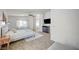 Large main bedroom has a seating area, ensuite bathroom, ceiling fan, and carpet at 412 Orchid Oasis Ave, North Las Vegas, NV 89031