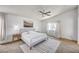 Bright main bedroom features a ceiling fan, a king-sized bed, and carpeted floors at 412 Orchid Oasis Ave, North Las Vegas, NV 89031