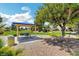 Park pavilion featuring a picnic table, landscaping, and shade from a tree on a sunny day at 412 Orchid Oasis Ave, North Las Vegas, NV 89031