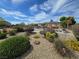 Neighborhood playground featuring colorful bushes, gravel ground cover and picnic tables at 412 Orchid Oasis Ave, North Las Vegas, NV 89031