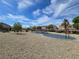 Community playground with blue sky, gravel ground cover and play structures at 412 Orchid Oasis Ave, North Las Vegas, NV 89031