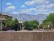 Scenic street view featuring lush trees and beautiful mountain views on a bright, sunny day at 412 Orchid Oasis Ave, North Las Vegas, NV 89031