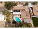 Aerial view showcasing a kidney-shaped pool, solar panels, and an open backyard oasis at 4219 E Pinecrest Cir, Las Vegas, NV 89121