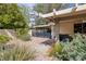 This cozy backyard area has gravel landscaping, a gate, a grill, and is surrounded by lush greenery, creating a serene outdoor space at 4219 E Pinecrest Cir, Las Vegas, NV 89121