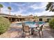 Charming backyard with a pool, lush landscaping, and an inviting outdoor dining area, perfect for entertaining at 4219 E Pinecrest Cir, Las Vegas, NV 89121