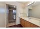 Bathroom featuring a shower with glass doors, a single sink vanity, and updated fixtures at 4219 E Pinecrest Cir, Las Vegas, NV 89121