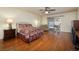 Spacious bedroom with hardwood floors, a queen bed, slider to the patio, and a ceiling fan at 4219 E Pinecrest Cir, Las Vegas, NV 89121