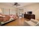Bright bedroom with wood floors, closet, ceiling fan, and slider to the patio at 4219 E Pinecrest Cir, Las Vegas, NV 89121