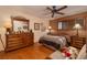 Traditional style bedroom with hardwood floors, wooden dresser, and a ceiling fan at 4219 E Pinecrest Cir, Las Vegas, NV 89121