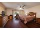 Cozy bedroom with hardwood floors, ceiling fan, window, and dresser at 4219 E Pinecrest Cir, Las Vegas, NV 89121