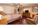 Comfortable bedroom featuring dark hardwood floors, ceiling fan, and classic wood furniture at 4219 E Pinecrest Cir, Las Vegas, NV 89121