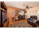 Cozy den with hardwood floors, wood shutters, a leather recliner, and a ceiling fan at 4219 E Pinecrest Cir, Las Vegas, NV 89121