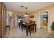 Cozy dining room features tile flooring and a view of the pool through the sliding glass door at 4219 E Pinecrest Cir, Las Vegas, NV 89121