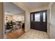 Inviting foyer with tile flooring leads to the living room, featuring hardwood floors and ample natural light at 4219 E Pinecrest Cir, Las Vegas, NV 89121