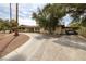 Charming single-story home with a long driveway, mature trees, and covered parking at 4219 E Pinecrest Cir, Las Vegas, NV 89121