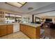 Bright open kitchen with tile countertops flows to the Gathering room with backyard views for seamless indoor-outdoor living at 4219 E Pinecrest Cir, Las Vegas, NV 89121