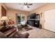 This spacious living room features a sliding glass door with a view of the pool area at 4219 E Pinecrest Cir, Las Vegas, NV 89121