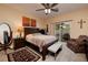 Cozy bedroom with neutral colors, a ceiling fan, and sliding glass doors to the outdoor space at 4219 E Pinecrest Cir, Las Vegas, NV 89121